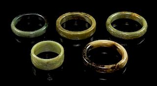 * A Group of Five Jade Bangles. Diameter of largest 3 1/2 inches.