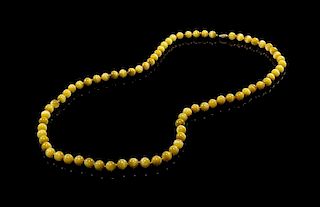 A Yellow Agate Cat's Eye Beaded Necklace. Length overall 17 1/2 inches.