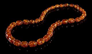 An Amber Beaded Necklace. Length overall 14 inches.
