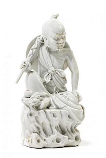 * A Blanc-de-Chine Porcelain Figure of a Luohan Height 10 inches.