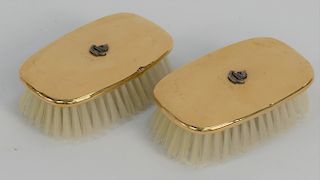 Three piece 14 karat gold lot to include a pair of 14 karat gold brushes, 
mounted with silver family crest, initialed J.J.S., and a...
