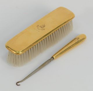 Tiffany & Co. 18 karat gold two piece set, 
brush and boot hook, marked Tiffany & Co. Makers. 
brush: length 7 inches 

Provenance: ...
