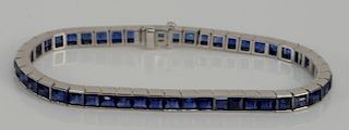 Cartier platinum and sapphire in line bracelet #15921.
length 6 7/8 inches, 21.8 grams