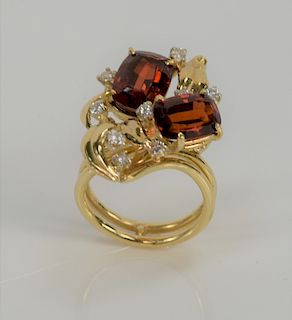 18 karat gold garnet and diamond ring, set with two rectangular garnets and nine brilliant cut diamonds. 
size 7, 11.6 grams total w...