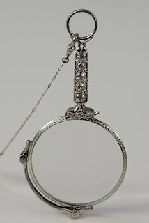 Platinum lorgnette on chain, handle set with eight diamonds.
35 grams total weight
