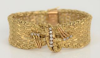18 karat gold mesh womens bracelet with wrap in center, mounted with twelve small diamonds, marked: 18K Chile. 
length approximately...