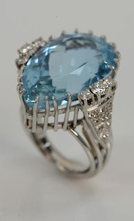 Platinum ring, set with pear shaped aquamarine approximately 21 cts. flanked by six round brilliant cut diamonds plus sixteen bead c...