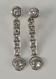 Pair of platinum and diamond dangle earrings with screw posts, 
each set with seven modern round and European cut diamonds, largest ...