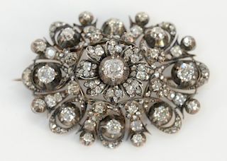 Georgian diamond brooch, silver top with 10 karat gold back, set with old mine and rose cut diamonds, 
center diamond of approximate...