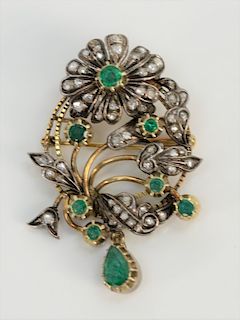 18 karat gold and silver brooch with rose cut diamond and round emeralds having one pear shaped emerald 6 x 9mm, all in floral desig...