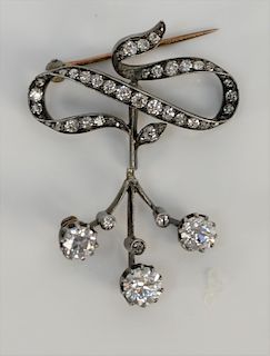 Georgian silver and 14 karat pin in floral design, the flowers are round European cut diamonds, approximately .64 cts., .69 cts., an...