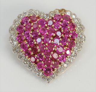 Platinum and 18 karat heart shaped brooch, center set with one pink stone and diamond surround. 
1 1/8" x 1 1/8", 12 grams total weight