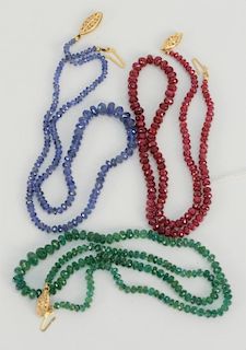 Three bead necklaces, all with 14 karat gold clasps to include one ruby, one blue sapphire, and one emerald. 
lengths 16 inches, 16 ...