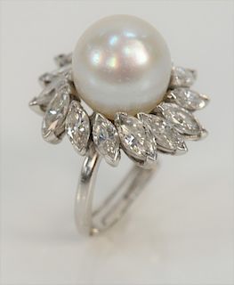 Platinum ring, set with center pearl surrounded by fourteen marquise diamonds, approximately .20 each, with ring guard. 
size 5