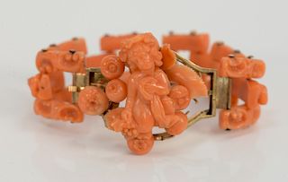 Coral and gold bracelet with carved putti, link carved putti and center putti with fruit, probably 19th century. 
length 6 1/2 inche...