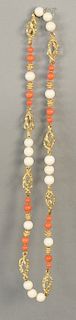 18 karat gold necklace, alternating with openwork gold, red coral, and white beads. 
length 27 inches