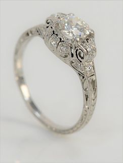 Platinum and diamond ring set with center diamond of approximately .80 cts., in filigree setting. 
size 6