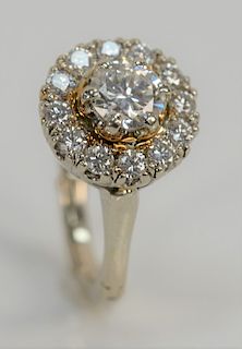 14 karat and diamond ring, set with center diamond of approximately 1 ct. surrounded by fourteen diamonds.