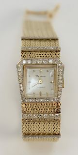 14 karat gold ladies wristwatch having square dial surrounded by diamonds with mesh gold band having two lines of diamonds on either...