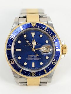 Rolex Submariner mens wristwatch, 
having blue dial and bezel gold and stainless band, being sold with original box and papers.
