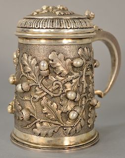 Continental silver covered tankard, the whole with embossed oak leaves and acorns. 
height 7 3/4 inches, 31.7 troy ounces
