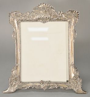 Large repousse Tiffany & Co. sterling silver frame, 
with stand having putti top and on feet, marked Tiffany & Co. 11526 + 1098 ster...