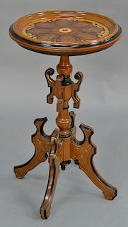 Renaissance Revival stand having round top, 
various woods inlays on turned pedestal, ending in four legs. 
height 28 1/2 inches, di...