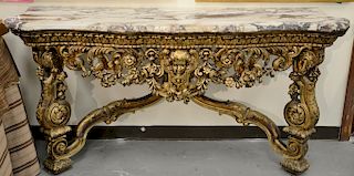 Pair of Louis XIV style console tables with shaped marble tops, 
on pierce carved tables with carved putti faces and scrolling flowe...