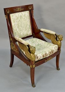 French Empire style Classical armchair with bronze mounted winged female hand rest, having gilt bronze mounts and paw feet. 
height ...