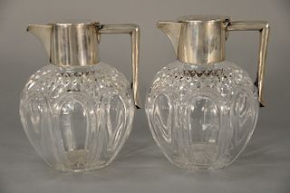 Pair of Tiffany & Co. clarets, 
having silver top and handle marked: J.G. & S. Tiffany & Co. Paris, on crystal bulbous form body, mo...