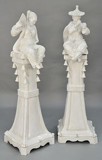Pair of large Continental white glazed, earthenware Majolica Oriental Chinoiserie seated figures, pedestal base having molded bells...