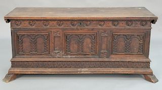Walnut cassone having lift-top with paneled and carved front on four feet, 17th - 18th century