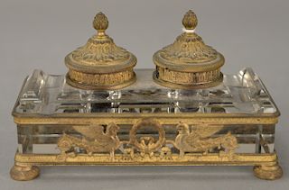 Crystal inkwell with double gilt bronze tops, on crystal block and set in gilt bronze frame with feet (one with ink liner missing). ...