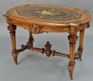 Renaissance Revival walnut center table having inlaid inset top, set on turned and fluted legs (minor imperfections to top). 
height...