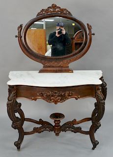 Victorian rosewood vanity with mirror and shaped white marble, having center drawer, scroll legs, and pierced carved stretchers wit...