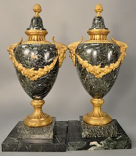 Pair of marble urns with gilt bronze mounts, 
each set on separate square bases (covers have chips). 
total height 22 inches