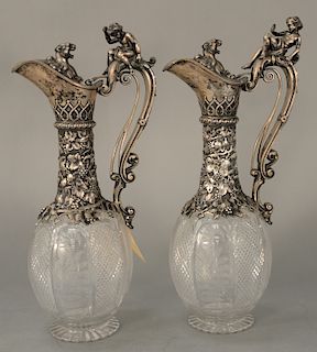 Pair of figural Claret Jugs,  silver tops over crystal body, handles mounted with putti fearing lion and lunging lion, pull handle...