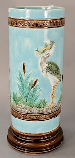 Majolica umbrella stand having crane with fish standing with cottontails.
height 22 1/4 inches, diameter 8 1/2 inches