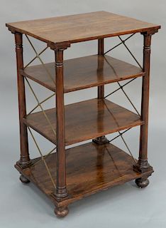 Rosewood etagere with rectangular top, 
over three shelves held up by turned columns and supported by brass X's, set on ball feet. 
...