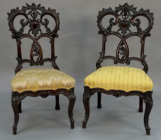 Set of ten mahogany Rococo side chairs, all with pierced shell carved backs (4-5 with chips).
height 42 3/4 inches