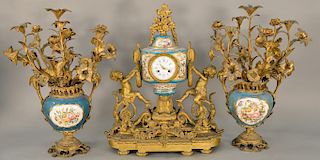 French Raingo Freres gilt bronze and porcelain three piece clock set, 
having Serves type body topped with gilt bronze flowers, all ...