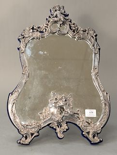 Figural sterling framed mirror, 
having putti figure on top with scrolling flowers, on scrolling feet with angel figure in center, m...