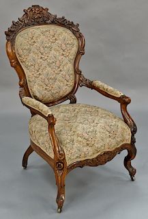 Rosewood Victorian gentleman's chair with foliate carved back and legs. 
height 43 1/4 inches