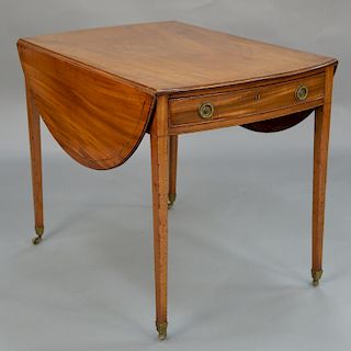 Georgian inlaid mahogany sofa table, 
drawer at one end, on casters, circa 1800. 
height 28 1/2 inches, top closed: 35 1/2" x 23 3/4...