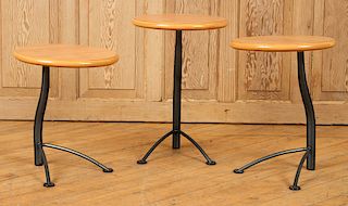 A SET OF THREE WOOD AND IRON TABLES