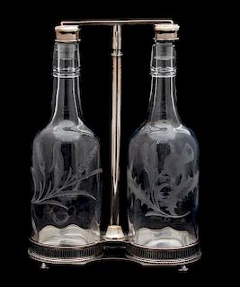 A Scottish Silver Plate Tantalus with Two Thistle Etched Bottles Height overall 12 inches.