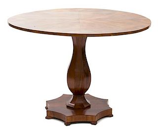 A Biedermeier Walnut Center Table Height 29 x diameter 42 inches.