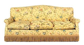 An Upholstered Three-Cushion Sofa Height 34 1/2 x width 82 inches.