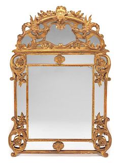 A Regence Style Giltwood Mirror Height 67 1/2 x width 47 inches.