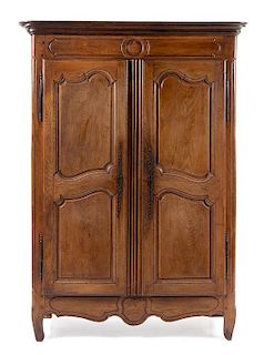 A Louis XV Provincial Walnut Armoire Height 77 x width 51 1/2 x depth 19 inches.